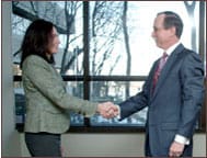 Photo of client and firm attorney shaking hands